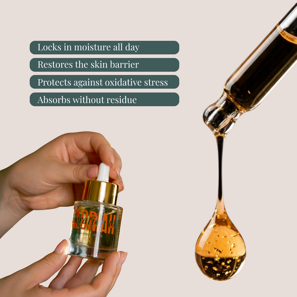 A hand holds a small glass dropper bottle of golden serum with a gold cap, next to a large dropper releasing a glossy drop of the same serum. Dark teal text on the left lists benefits: locks in moisture all day, restores the skin barrier, protects against oxidative stress, and absorbs without residue.