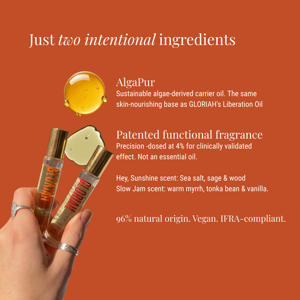 A hand holds two small AlgaPur roll-on vials with gold caps against a solid orange background. White text on the image describes the product's ingredients and scent notes.