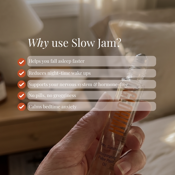 A hand holds a Slow Jam essential oil rollerball tube in a softly lit bedroom setting. Large text on the left reads 'Why use Slow Jam?' with five benefit bullet points overlaid on the photo.