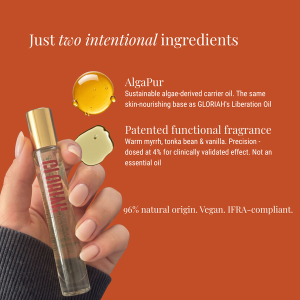 A hand holds a clear cylindrical cosmetic bottle with a gold cap against a solid orange background. White text describes the product ingredients, including AlgaPur carrier oil and a patented fragrance, with small gold and cream droplet graphics above.