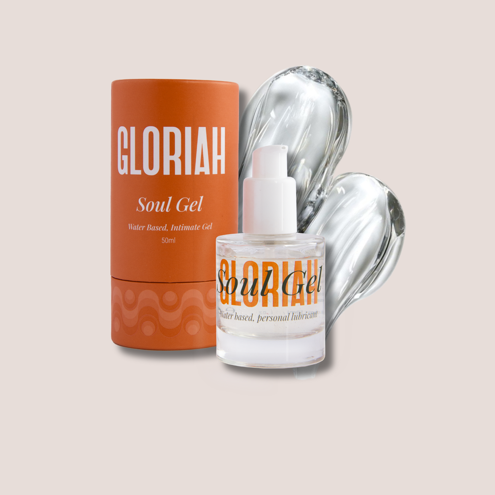 Gloriah Soul Gel water-based intimate gel shown with its orange cylindrical packaging and a clear bottle of the gel, set against a solid light beige background.